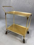 Vintage gold coloured two-tier tea trolley on castors