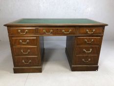 Twin pedestal leather-topped writing desk with brass handles, approx 140cm x 77cm x 77cm