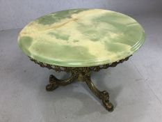 Elaborate brass mid century coffee/occasional table. Standing on three legs with a green agate