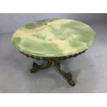 Elaborate brass mid century coffee/occasional table. Standing on three legs with a green agate