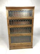 Glazed and leaded Globe Wernicke four section bookcase with drawer to base, approx 86cm x 30cm x