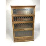 Glazed and leaded Globe Wernicke four section bookcase with drawer to base, approx 86cm x 30cm x