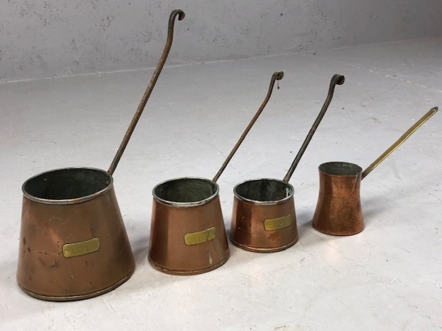 Collection of four antique copper spirit measures