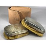 Pair of hallmarked silver clothes brushes with engine turned decoration hallmarked for London by