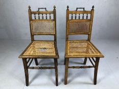 Pair of antique cane seated and backed chairs, with handles to top (A/F)