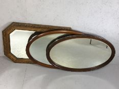 Collection of three wooden framed mirrors, two oval, all bevel-edged, the largest approx 83cm in