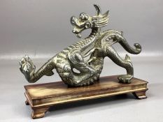 Cast metal Chinese figure of a dragon on wooden base, approx 23cm in length