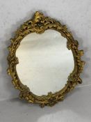 Oval gilt framed mirror, approx 65cm x 47cm