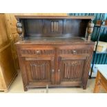 Small, carved, dark wood sideboard with shelf above, two drawers and shelving under