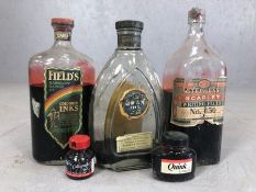 Five bottles of ink in various sizes