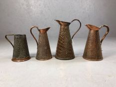 Collection of four antique hammered and snakeskin design copper jugs, the tallest approx 28cm in