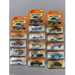 Fourteen Matchbox Mattel Wheels model diecast vehicles, all in sealed orange blister packs
