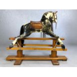 Vintage wooden hand-painted, English-made rocking horse with original leather saddle, with horse
