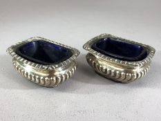 Pair of Birmingham hallmarked silver salts with blue glass liners by maker Henry Williamson Ltd