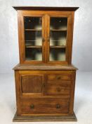 Apprentice piece miniature bookcase with glass doors over and a range of drawers beneath, approx