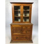 Apprentice piece miniature bookcase with glass doors over and a range of drawers beneath, approx