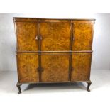 Large walnut drinks cabinet by maker S. &. H. Jewell, London, with three cupboards over and three