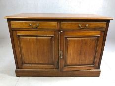 Low antique cupboard with two drawers and original handles, approx 107cm x 51cm x 73cm tall