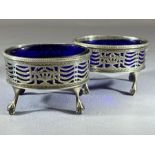 Pair of George III Oval Silver hallmarked salts with blue glass liners (A/F) on tall bird feet