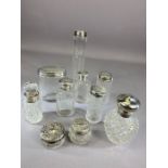 Collection of ten silver topped scent bottles with various hallmarks and ages