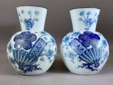 Pair of opaline glass vases, white ground with blue floral decoration, marked '5' to base, each