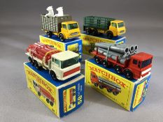 Four boxed Matchbox Series diecast model vehicles: 4 Stake Truck, 10 Pipe Truck, 37 Cattle Truck, 58
