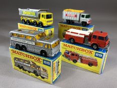 Four boxed Matchbox Series diecast model vehicles: 11 Scaffolding Truck, 29 Fire Pumper Truck, 51
