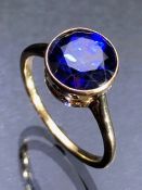 Gold (Unmarked) Dress Ring set with a 92mm diameter Blue Faceted Gemstone Size N½.