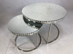 Nest of two mirror topped occasional tables on chrome bases, the largest approx 76cm in diameter