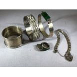 Collection of silver items to include bangles, bracelets and a napkin ring (6)