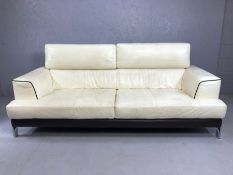Italian cream leather sofa with brown leather piping on chrome feet, with adjustable headrest,