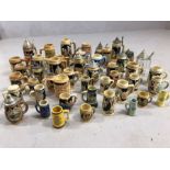 Large collection of steins, mostly German, in varying sizes and of varying design, some with