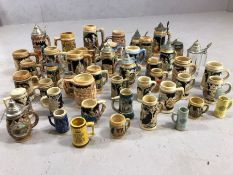 Large collection of steins, mostly German, in varying sizes and of varying design, some with