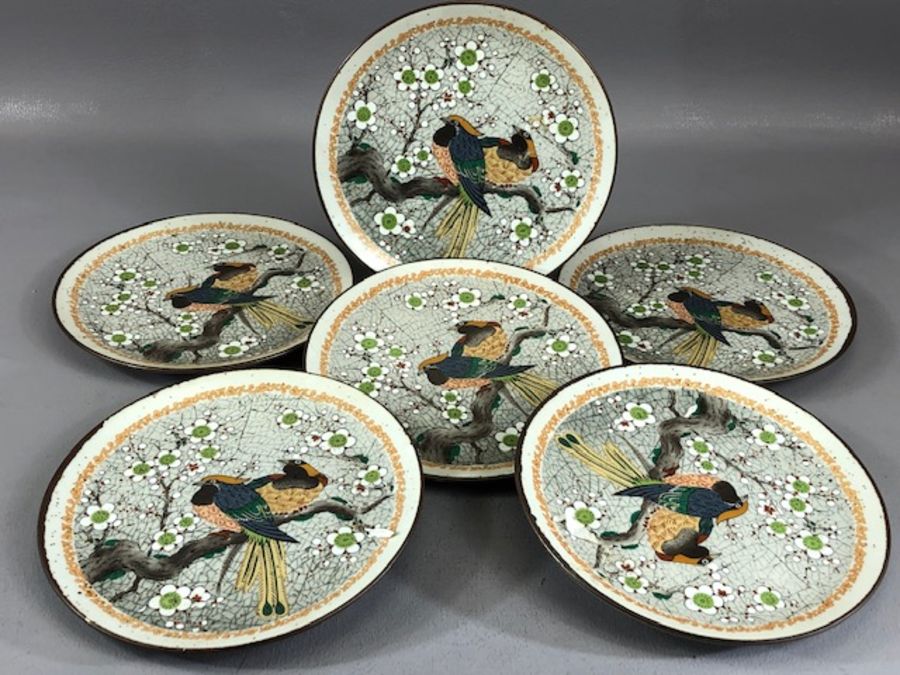 Collection of six Oriental stoneware plates decorated with birds on a branch, surrounded by flowers,