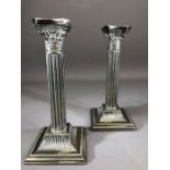 Pair of Silver coloured Corinthian Style candlesticks approx 21cm tall