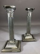 Pair of Silver coloured Corinthian Style candlesticks approx 21cm tall