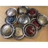 Collection of eleven Mercedes hubcaps, in multiple colours