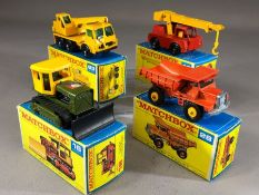 Four boxed Matchbox Series diecast model vehicles: 16 Case Tractor, 42 Iron Fairy Crane, 28 Mack