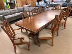Contemporary extending dining room table and eight chairs with linen upholstered seats, two carvers,