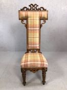 Occasional tartan upholstered prayer chair with carved detailing