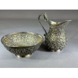 Indian Silver bowl and jug with flora and fauna repousse design and the jug handle a cobra, the bowl