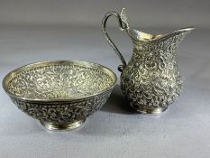 Indian Silver bowl and jug with flora and fauna repousse design and the jug handle a cobra, the bowl