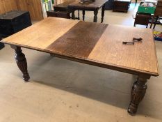 Oak Victorian dining table on carved legs with winder and additional leaf