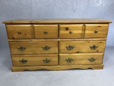 Modern pine-effect chest of eight drawers, approx 150cm x 44cm x 78cm tall