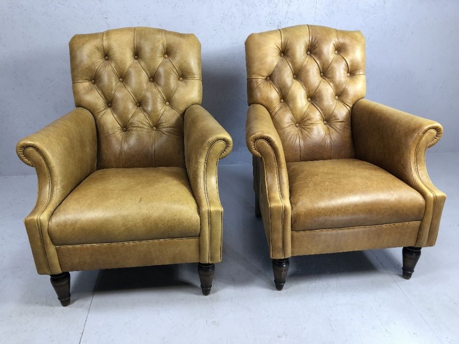 Pair of leather / cattle hide tan fireside button back chairs, by Laura Ashley