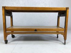 Vintage Mid Century teak metamorphic two tier tea trolley / table with pull-out lower tier raised on