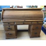 Modern pine roll-top desk with seven drawers and internal pigeon holes, approx 141cm x 49cm x