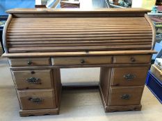 Modern pine roll-top desk with seven drawers and internal pigeon holes, approx 141cm x 49cm x