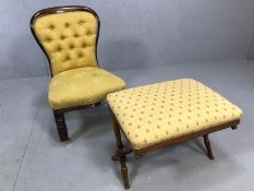 Low upholstered occasional chair / nursing chair on brass front castors with button back