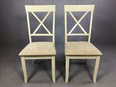 Pair of modern white painted chairs with cream faux suede seat pads